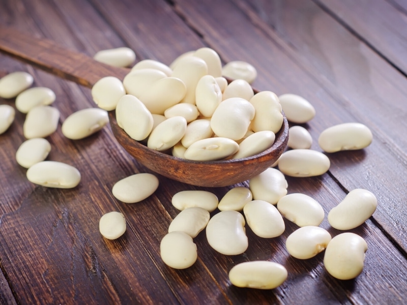 White Beans on a Wooden Spoon and Table