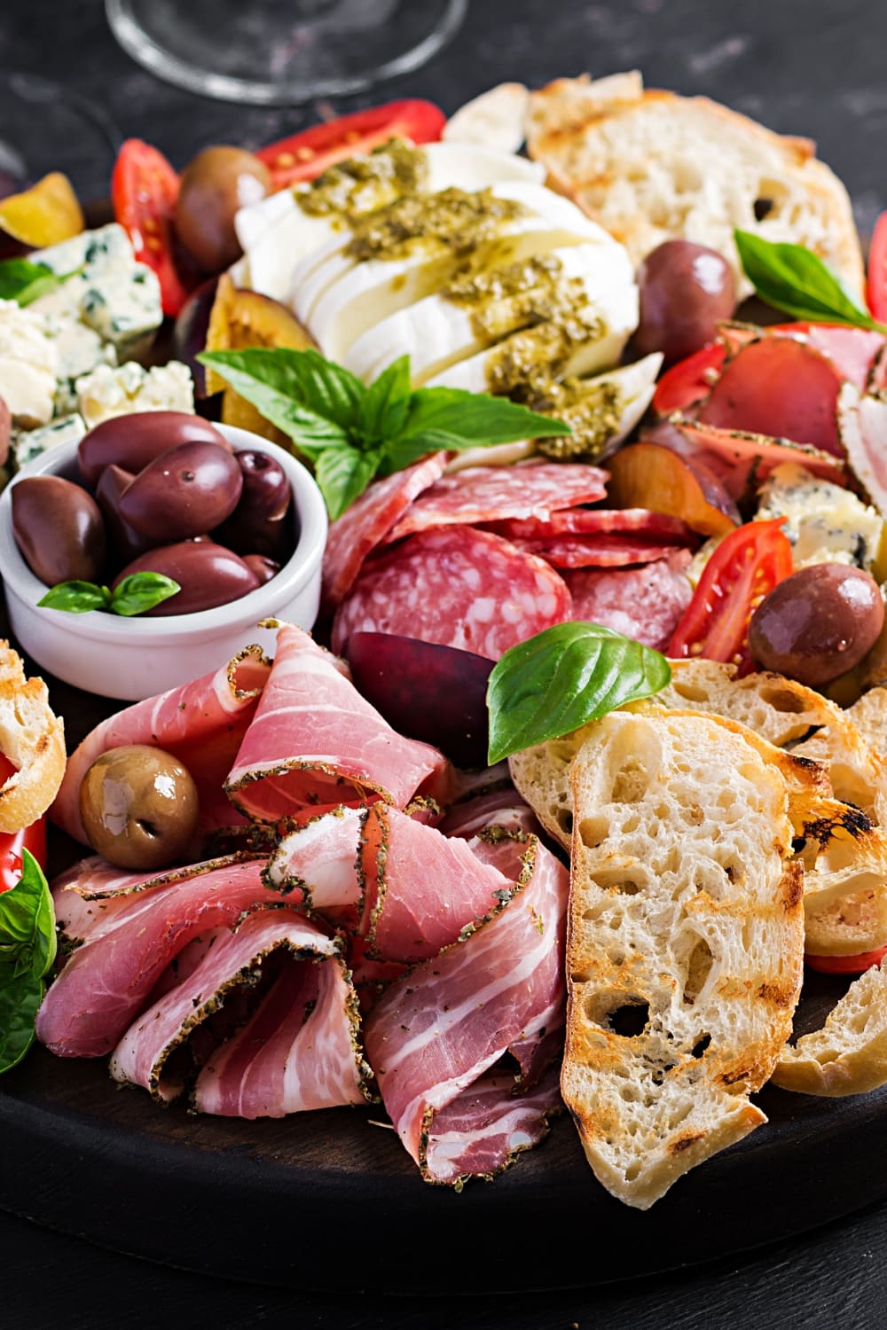 Antipasto Platter with Ham, Prosciutto, Olives, Bread, Tomatoes,  and Cheese