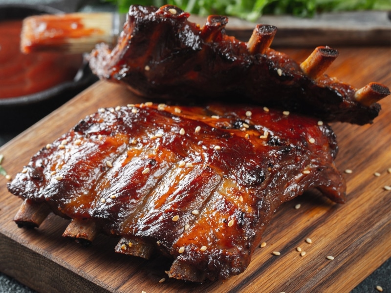 Barbecue Ribs in a Wooden Cutting Board with Sesame Seeds