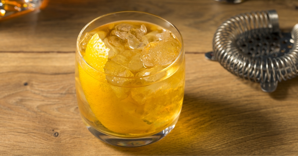 Boozy Homemade Rusty Nail Cocktail with Orange and Garnish in a Glass