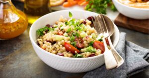 Bowl of Homemade Couscous Salad with Tomatoes and Herbs
