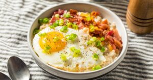 Bowl of Homemade Oatmeal with Egg, Green Onions and Crispy Bacon