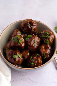 Bowl of Homemade Sweet and Sour Meatballs with Parsley