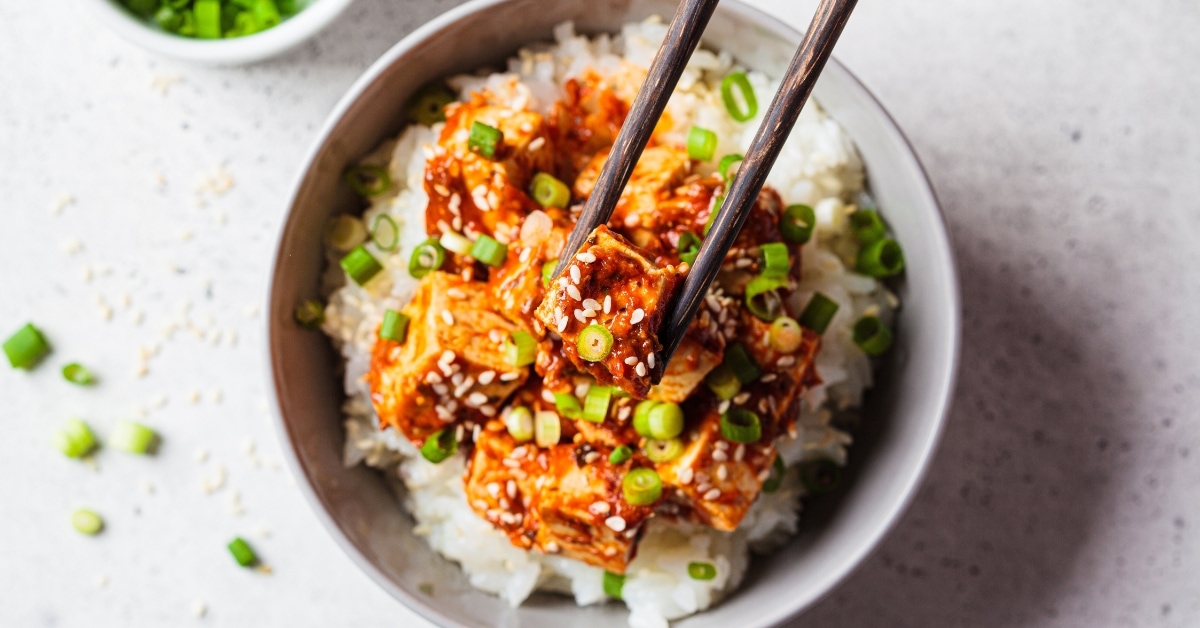 Bowl of Tofu and Rice with Green Onions and Sesame Seeds