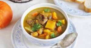 Bowl of Pumpkin and Beef Soup with Carrots and Potatoes