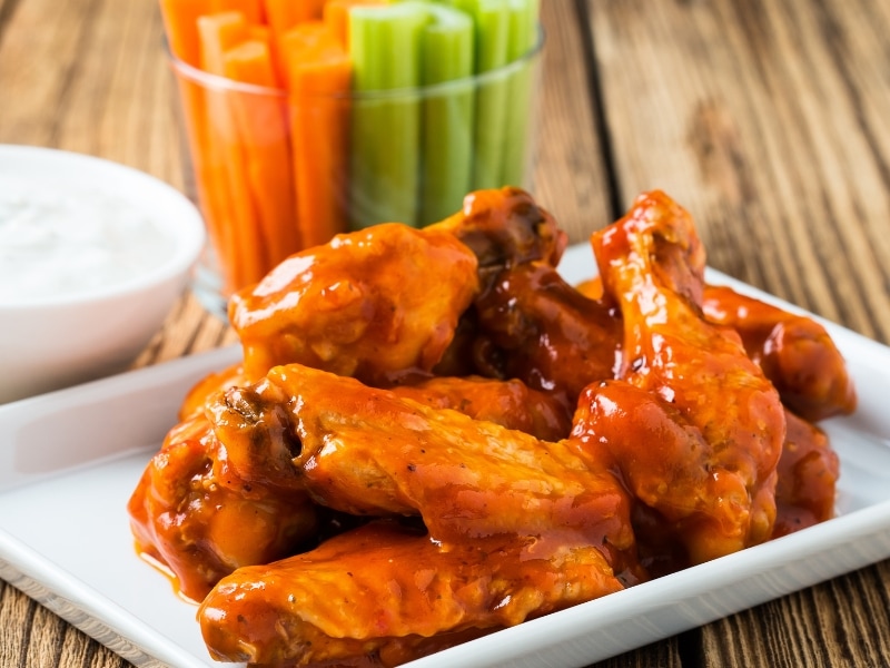 Buffalo Wings on a Serving Plate with Carrots and Celery Sticks