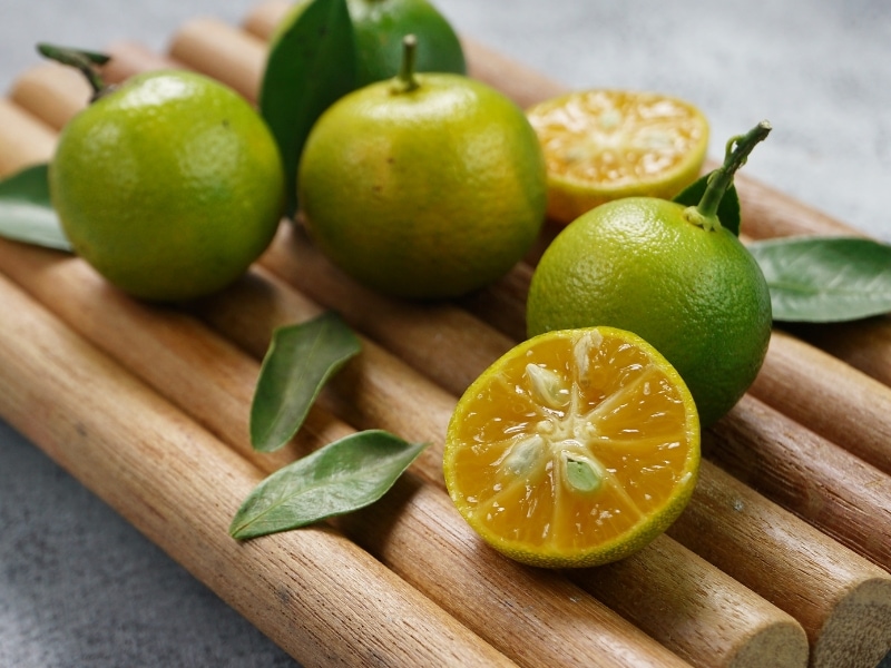 Calamondin/Calamansi with Leaves in a Wooden Board
