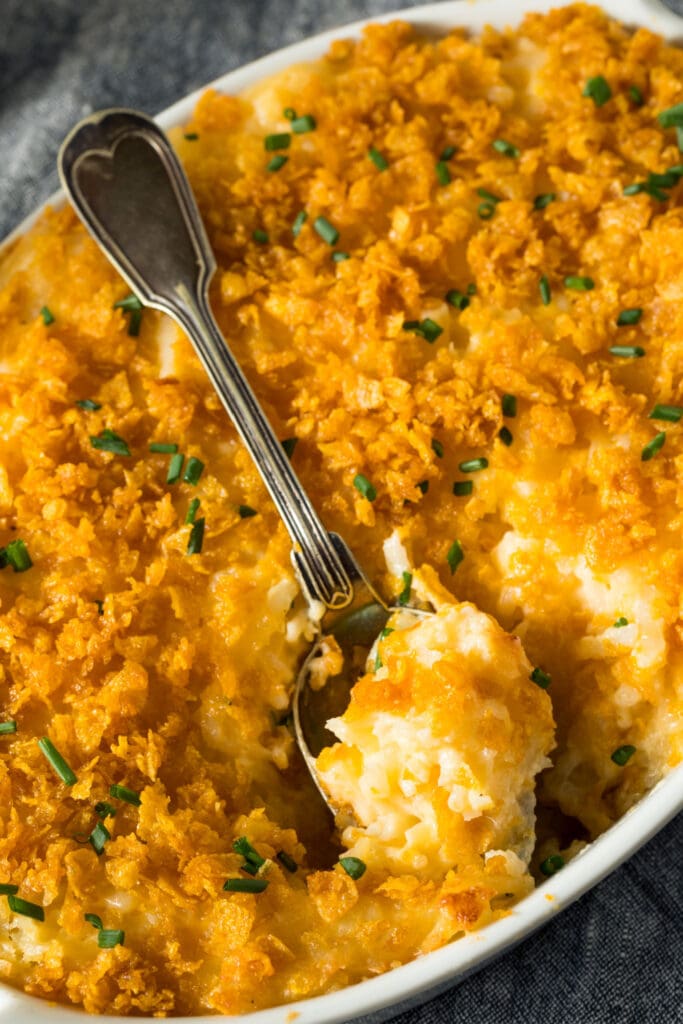 Cheesy Potato Casserole with A Spoon Scooping