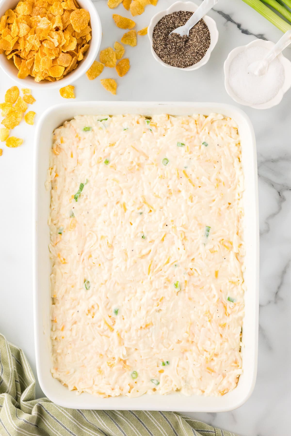 Cheesy potato casserole ingredients in a baking dish