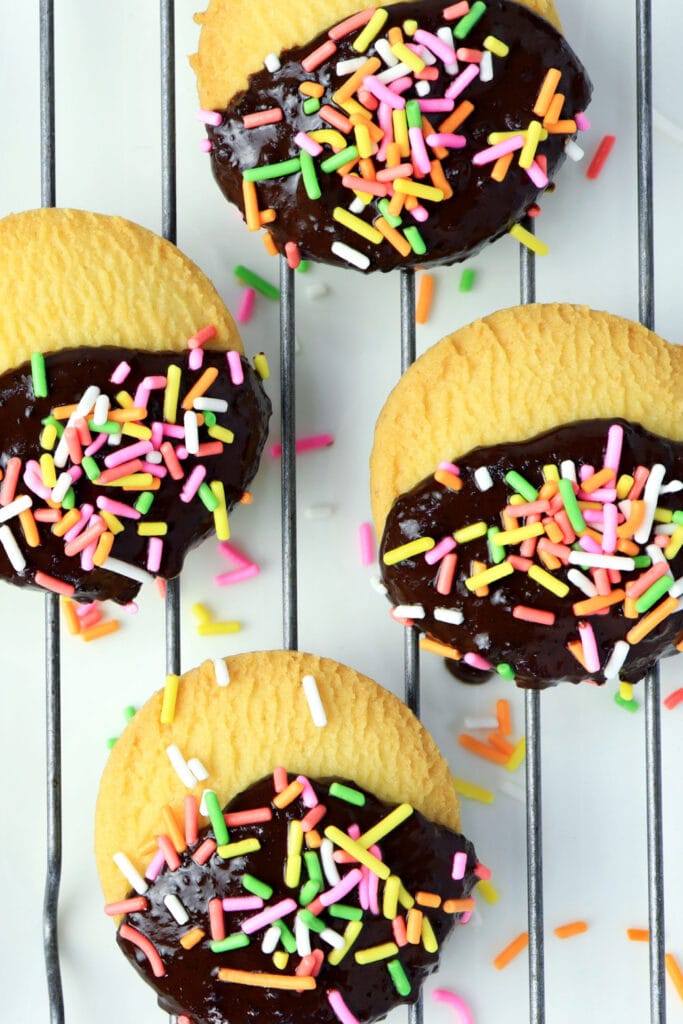 Chocolate-Dipped-Shortbread-Cookies on a Baking Rack Garnished With Colorful Sprinkles