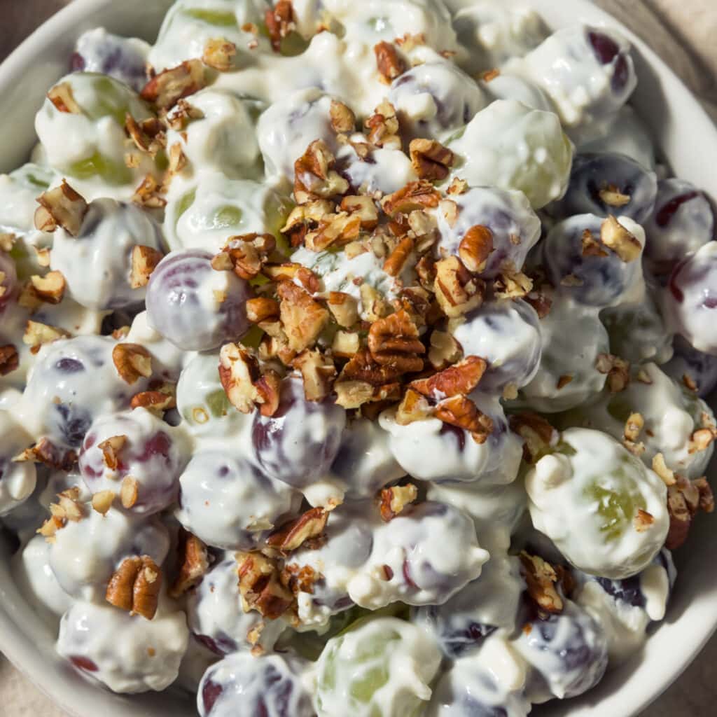 Creamy Grapes Salad Topped With Crushed Pecan Nuts