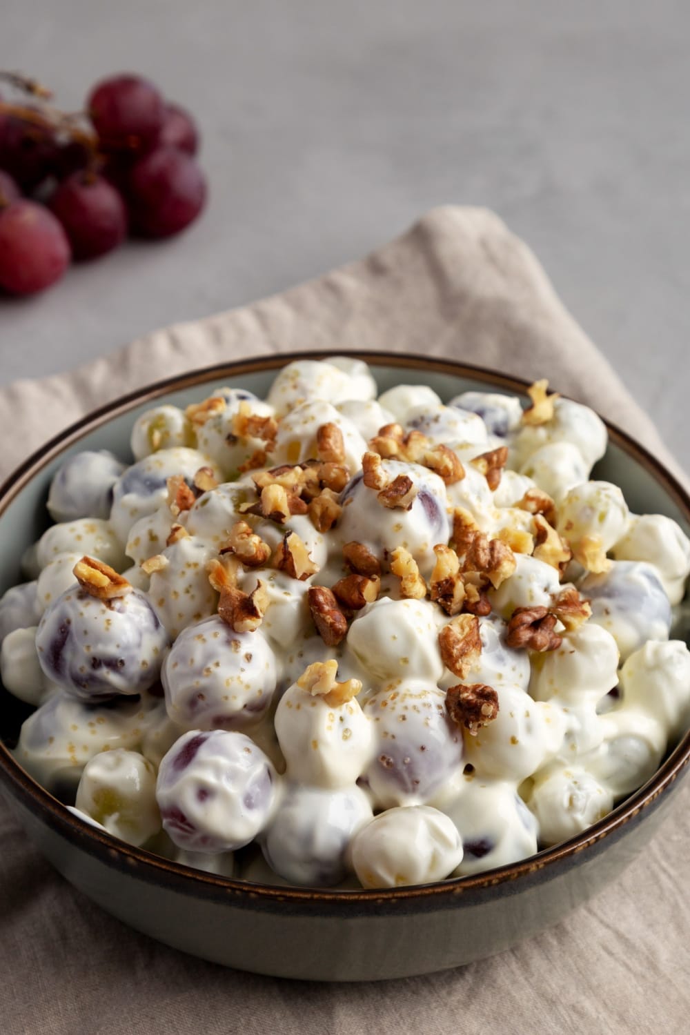 Bowl of Creamy Grapes Salad with crushed walnuts on top