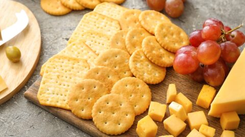 Different Crackers in a Charcuterie Board with Cheese and Grapes