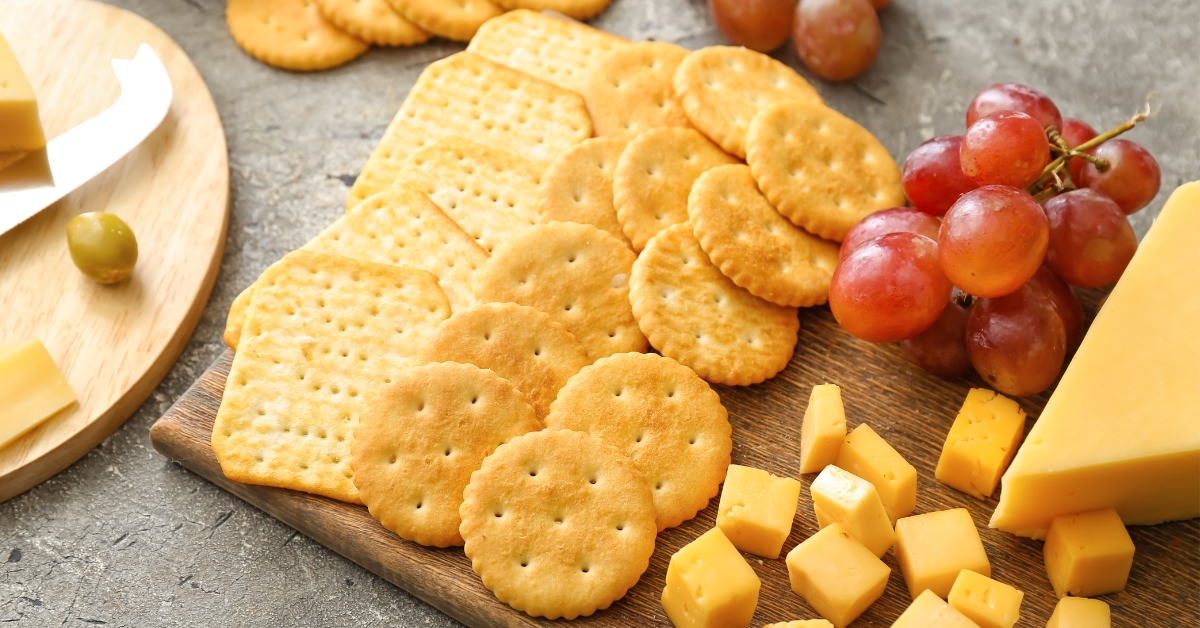 Different Crackers in a Charcuterie Board with Cheese and Grapes