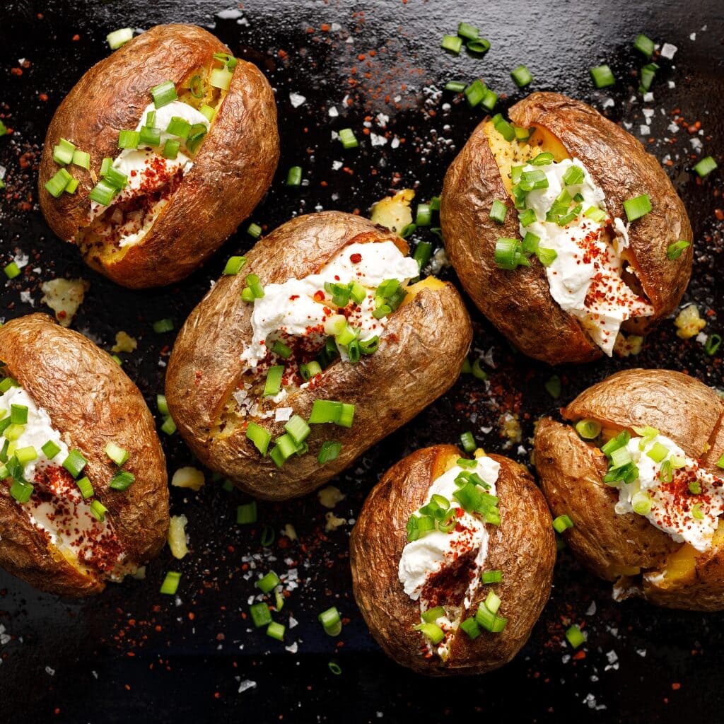 Homemade Baked Potatoes Stuffed with Green Onions, Sour Cream and Paprika