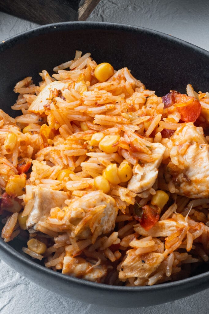 Close up of Mexican Chicken and Rice in a Black Bowl