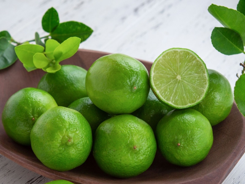 Persian Limes Whole and Sliced in a Wooden Bowl