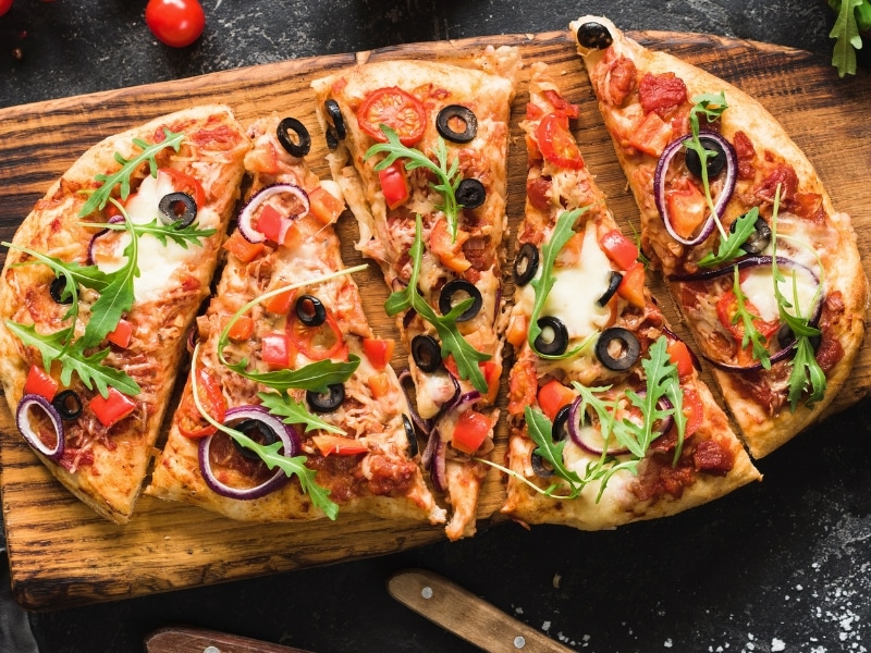 Pizza Slices on a Wooden Cutting Board
