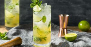 Refreshing Dark Rum Mojito with Ice and Lime in a Glass