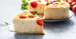 Slice of Homemade Savory Cheesecake with Tomatoes and Mint