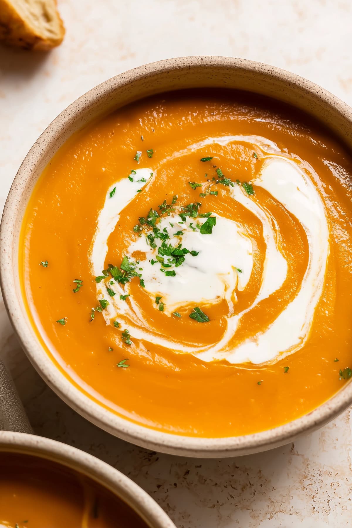 Creamy sweet potato soup with yogurt and herbs in a bowl. - 4