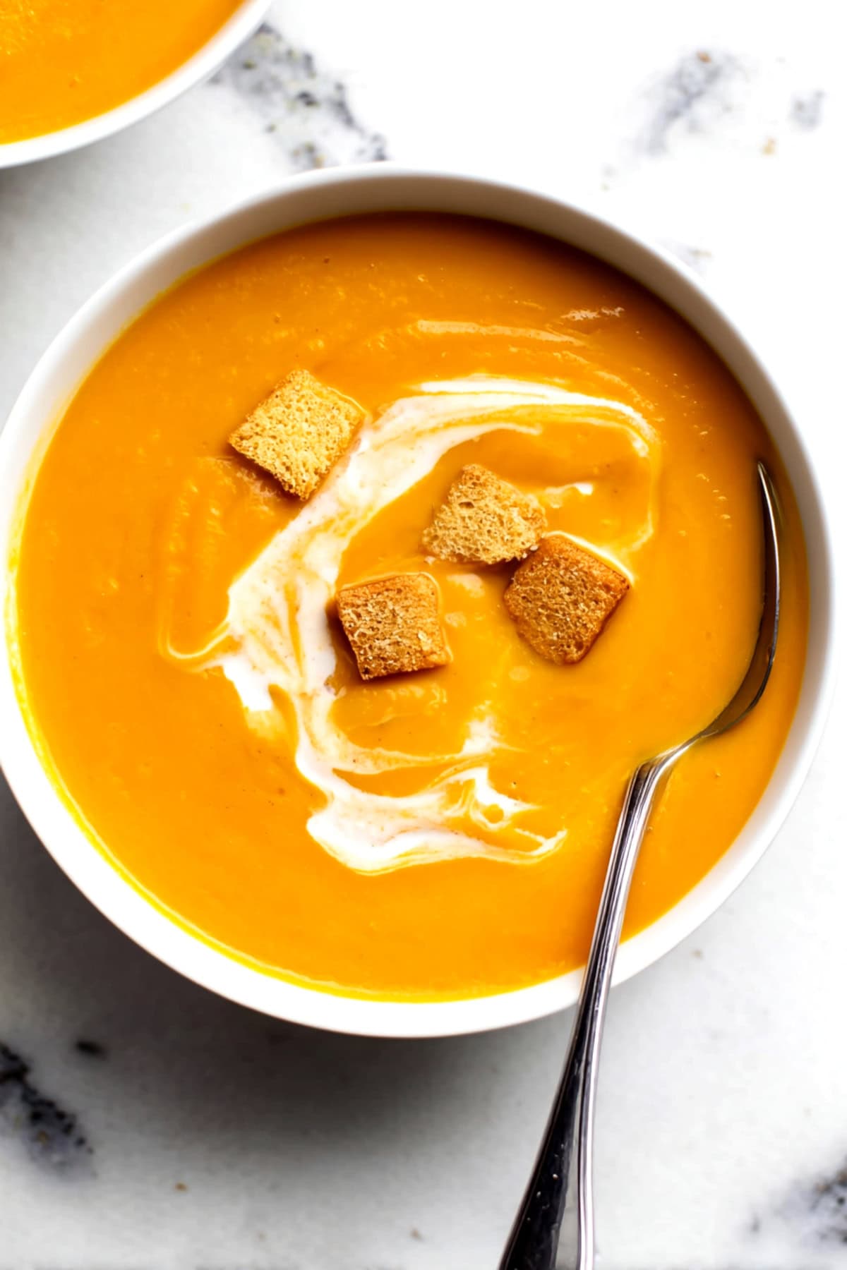 Sweet potato soup with croutons in a bowl, top view. - 9