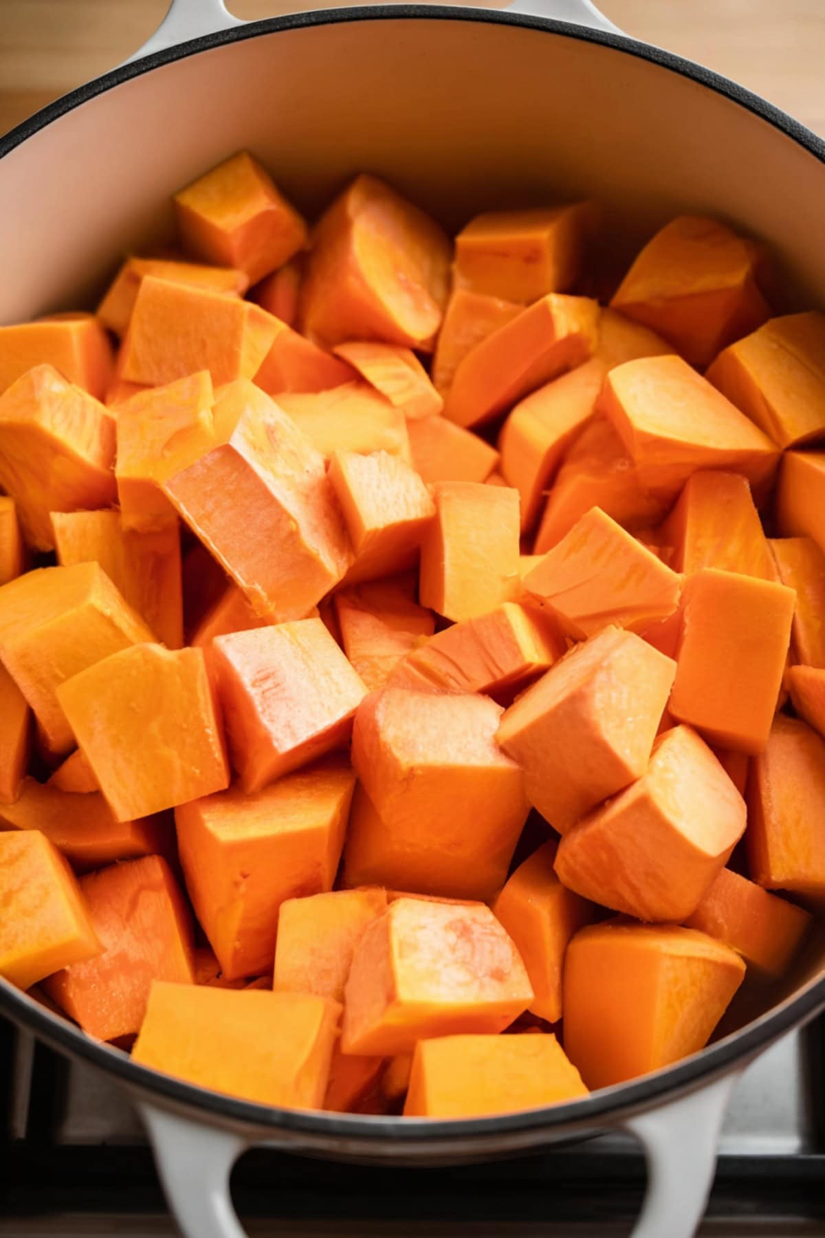 Chopped sweet potatoes in a Dutch oven. - 6