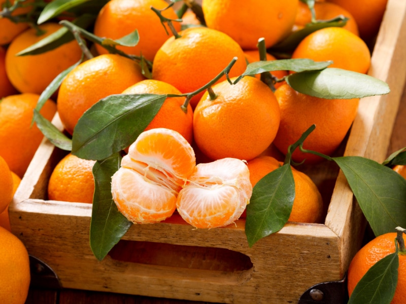 Tangerines with Leaves in a Wooden 
Box