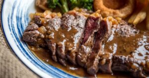 Tasty Flank Steak with Gravy Sauce, French Fries and Fried Onions