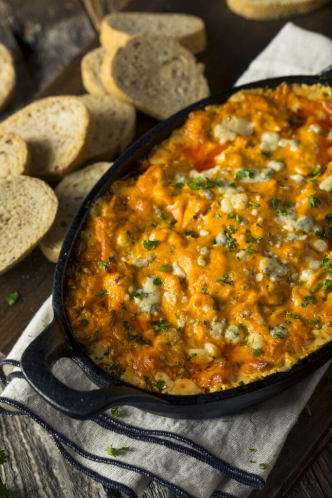 buffalo chicken dip with crostini on background
