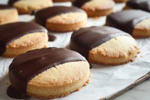 Chocolate-Dipped Shortbread Cookies On Parchment Paper