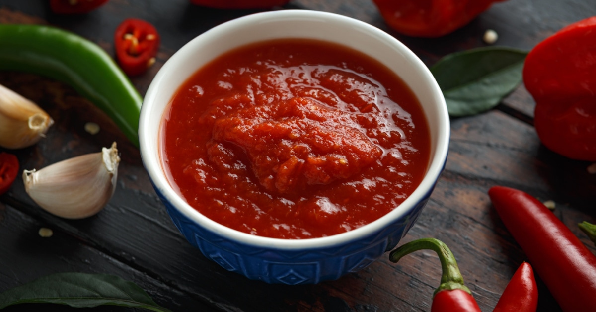 red chili sauce in wooden background