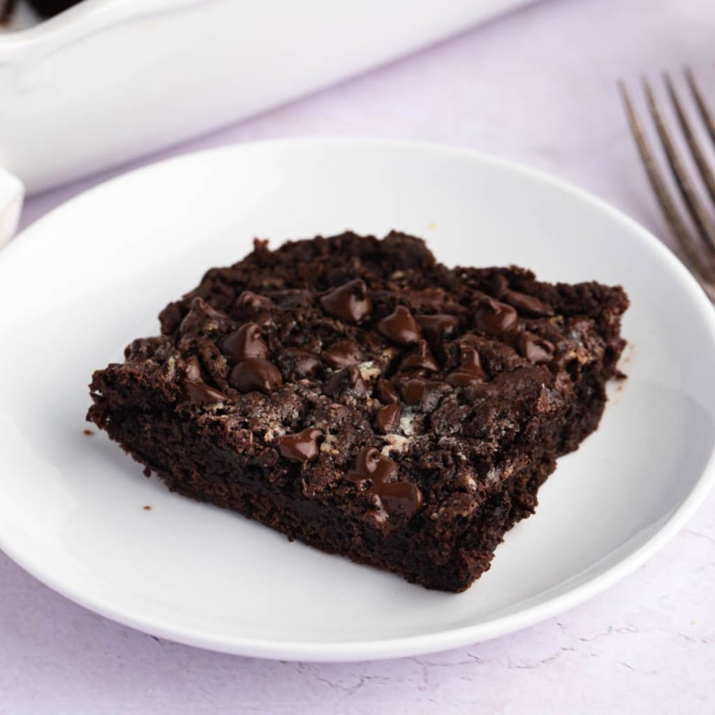 A Piece of Chocolate Dump Cake with Chocolate Chips in a Plate