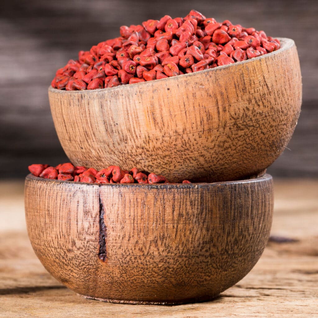 Annatto Seeds in a Wooden Bowl