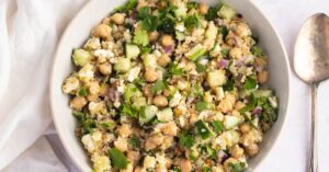 Bowl of Healthy Homemade Salad with Quinoa, Cucumber, Peas and Red Onions