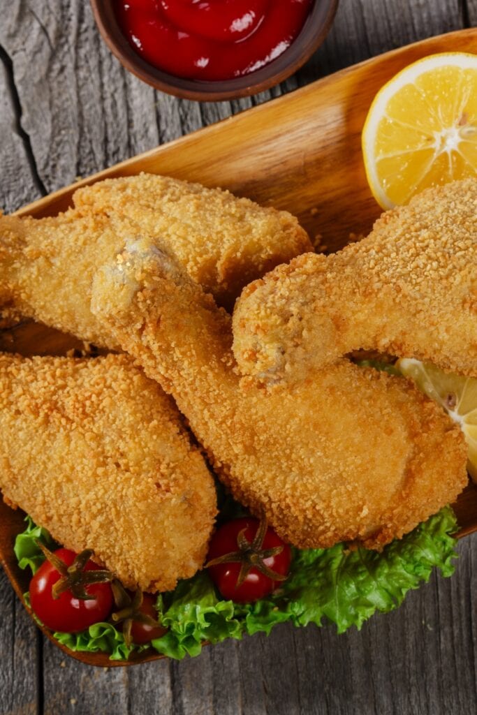 Breaded Fried Chicken Legs with Lemon and Ketchup