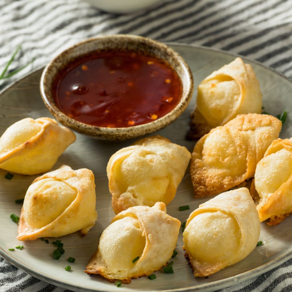 Crispy Cream Cheese Wonton on Plate With Dipping Sauce
