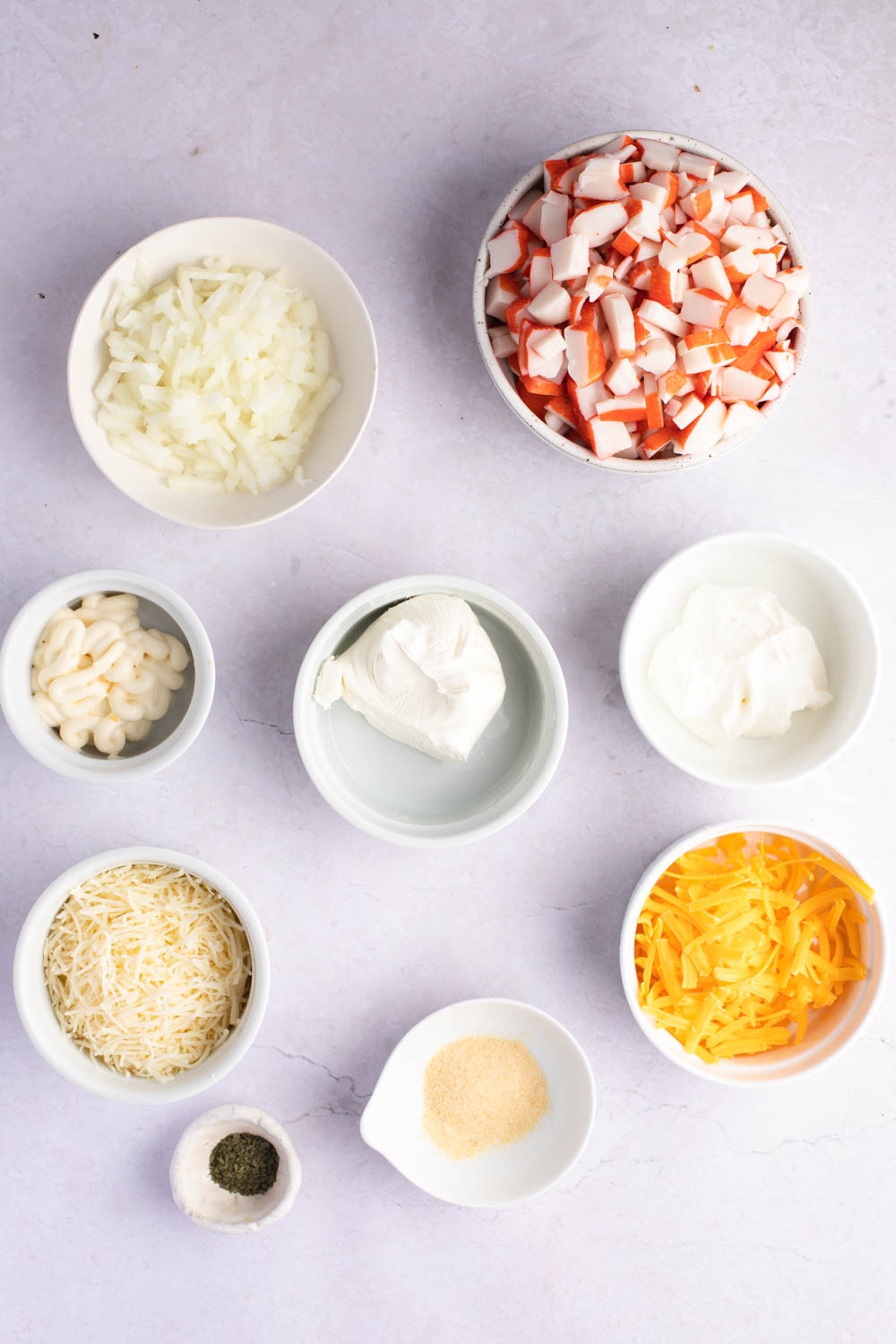 Crab Casserole Ingredients - Imitation Crab, Onion, Mayonnaise, Cheese, Garlic, Powder and Parsley