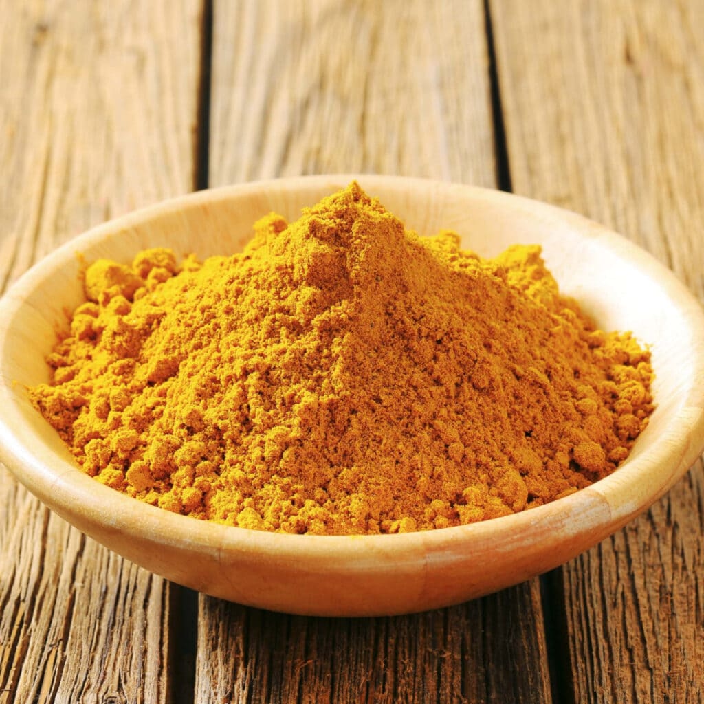 Heap of Curry Powder in a Wooden Saucer
