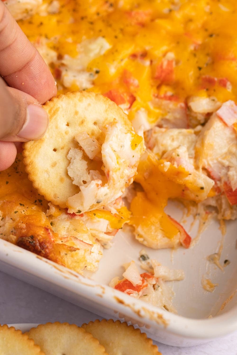 Dipping a Biscuit in a Cheesy Crab Casserole
