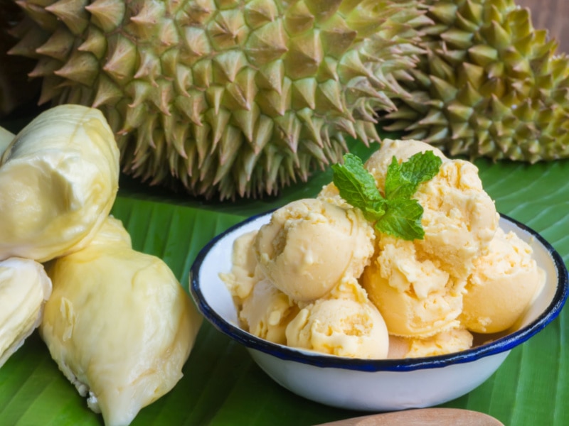 Durian Ice Cream on a While Bowl With Fresh Durian on the Background