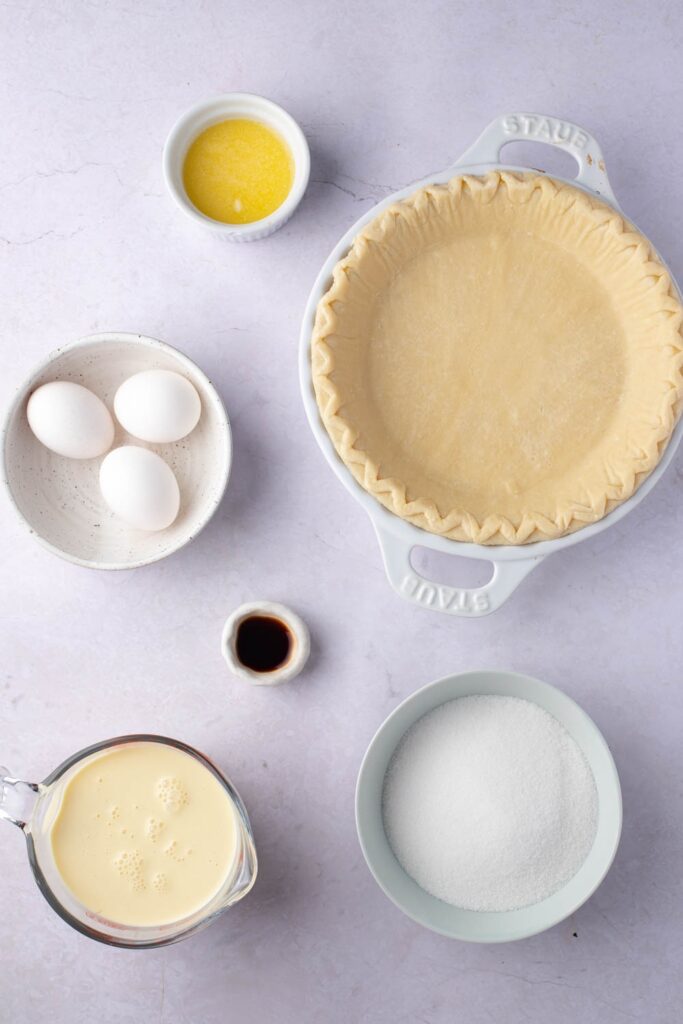 Eggnog Pie Ingredients - Sugar, Flour, Eggnog, Eggs, Vanilla Extract, Butter and Unbaked Pie Crust