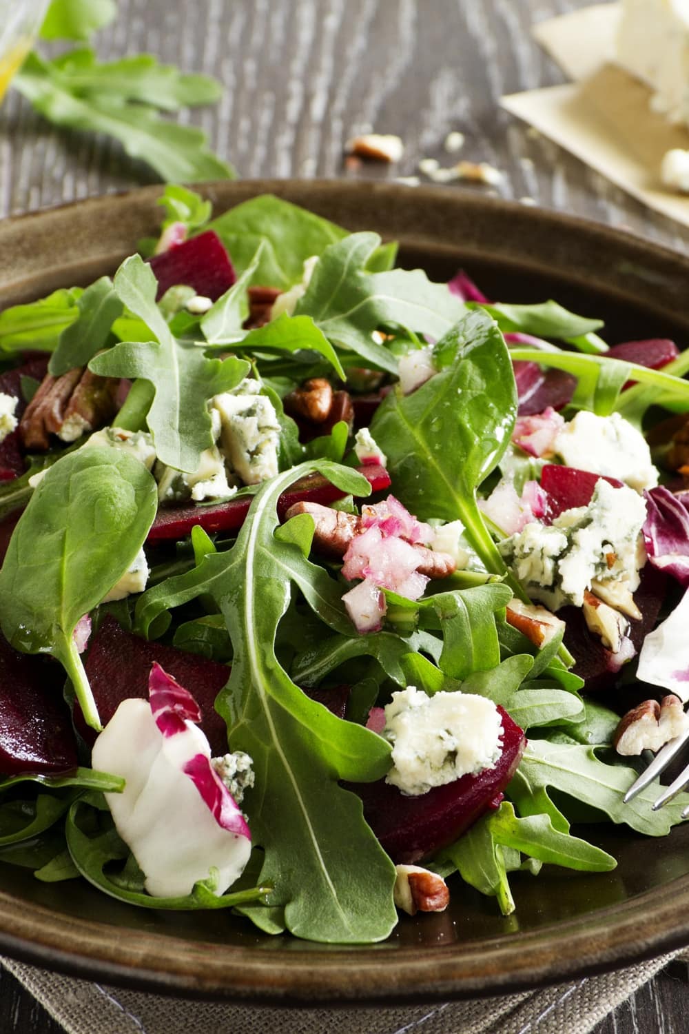 Fresh salad with beets, fresh spinach, cottage cheese and chopped nuts.