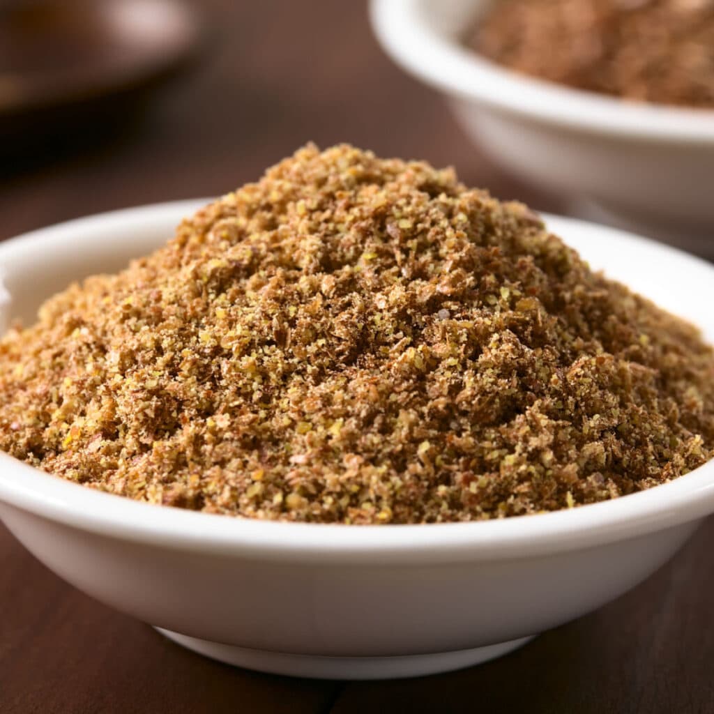 Ground Flaxseed in a White Ceramic Bowl 