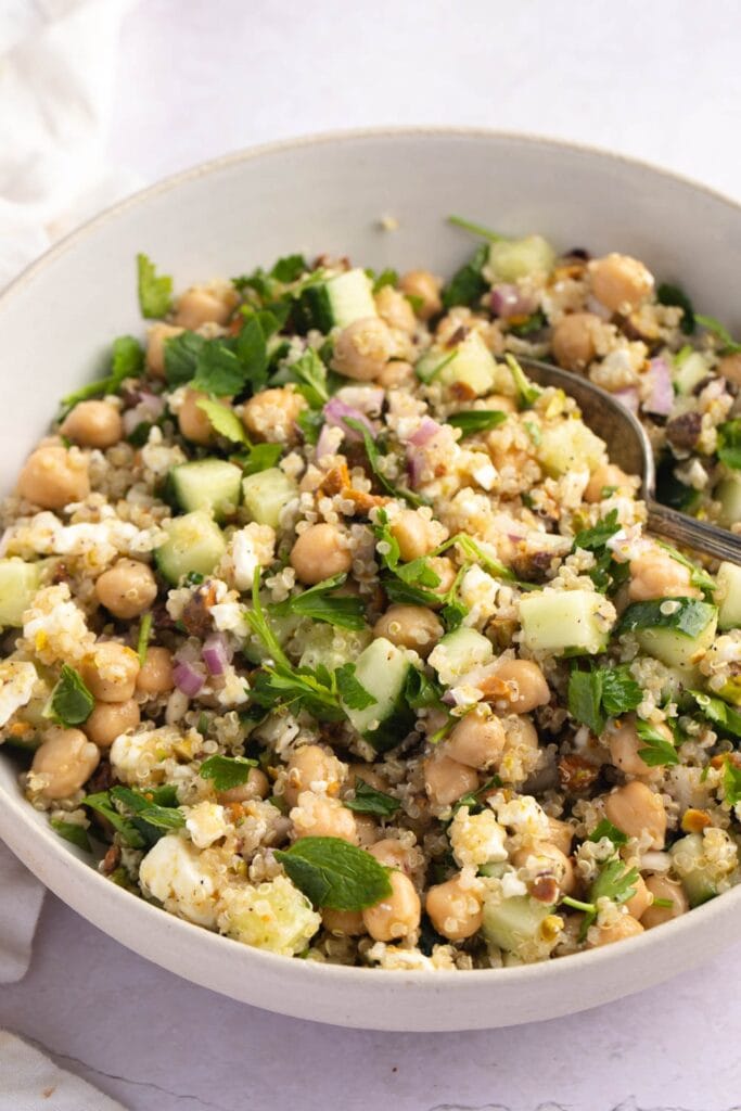 Healthy Salad with Quinoa, Cucumber, Parsley and Onions in a White Bowl