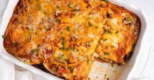 Homemade Cheesy Taco Lasagna with Ground Beef and Onions in a Casserole