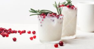 Homemade Coconut Cocktail with Red Cranberries and Rosemary