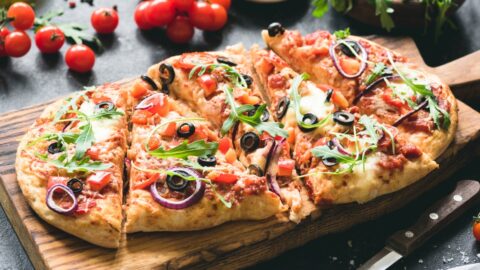 Homemade Flatbread Pizza with Arugula and Onion Toppings