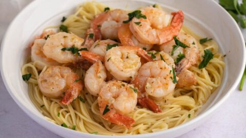 Homemade Shrimp Scampi with Pasta and Herbs in a White Bowl