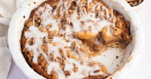 Homemade Soft and Fruity Cinnamon Roll Dutch Apple Pie in a White Casserole